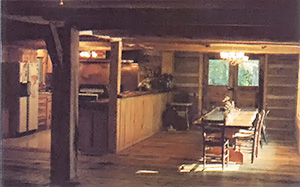 The dining room is separated from the kitchen by a long counter, which makes food preparation and service easy and efficient.